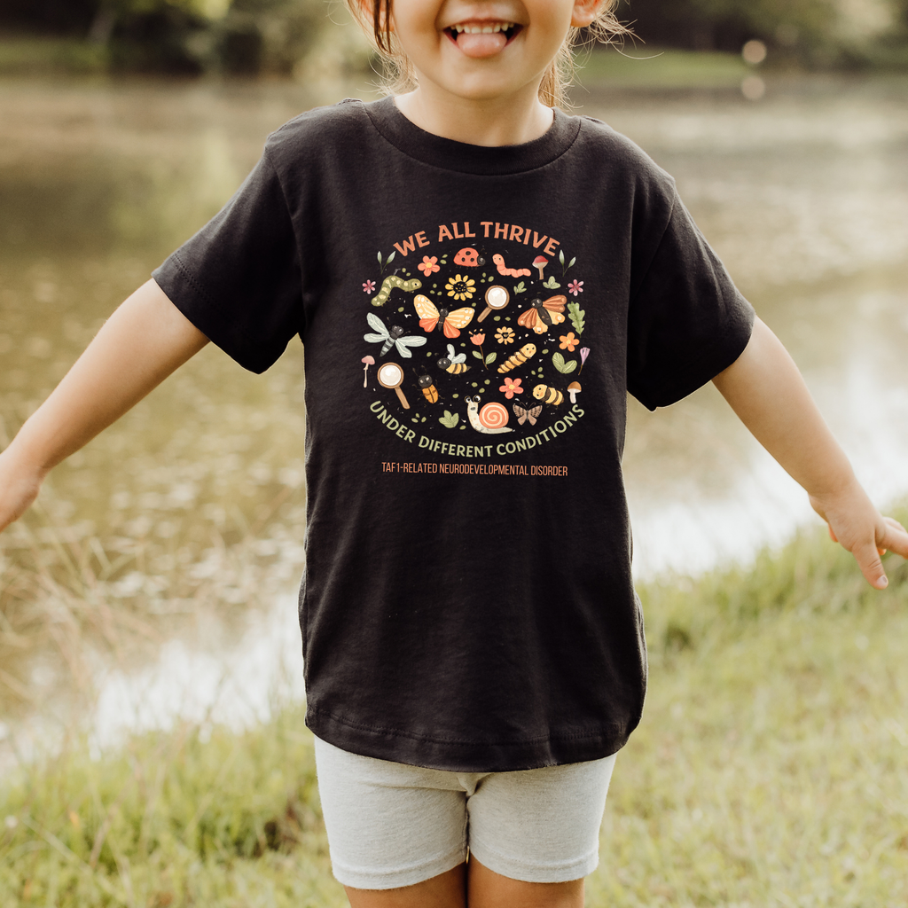 Toddler Tee — "We All Thrive" TAF-1 Neurodevelopmental Disorder Awareness Shirt